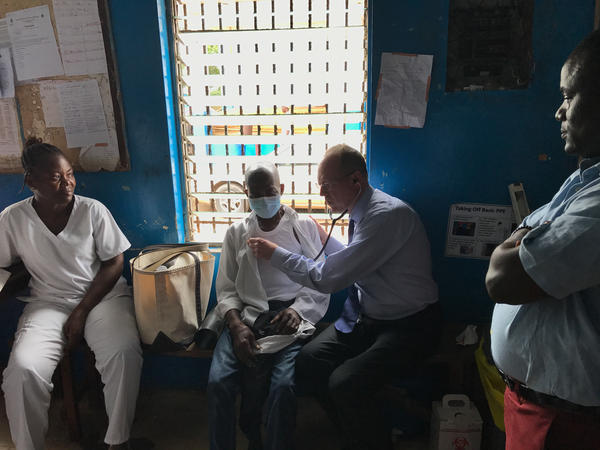 Dr. Paul Farmer examines a tuberculosis patient in Monrovia, Liberia.