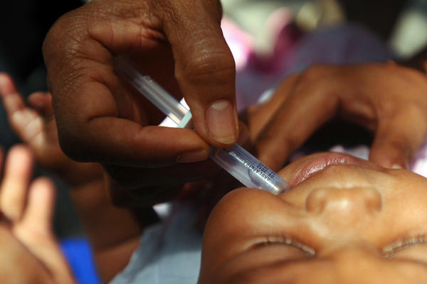 A nurse vaccinates a baby against rotavirus, a deadly form of diarrhea.
