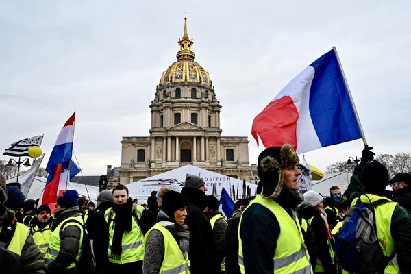 Protesters take part in an antigovernment yellow vest demonstration in front of the Hôtel National des Invalides in Paris early in January.