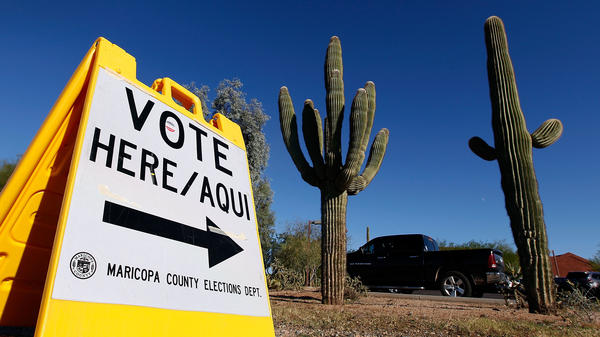 A sign directs voters to a polling station on Nov. 8, 2016, in Cave Creek, Arizona. The state is one of several considering new voting laws that could make it more complicated to vote in 2020.