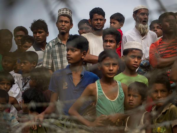 Rohingya refugees gather in the "no man's land" behind Myanmar's barbed-wire-lined border in Maungdaw district, Rakhine state, in 2018. Some 700,000 refugees fled into Bangladesh following a brutal crackdown by the Myanmar military in 2017.