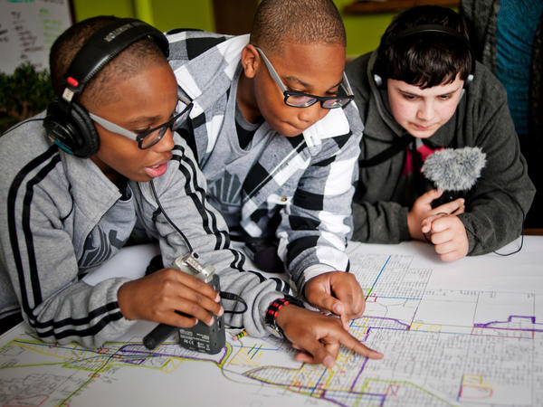 From left, students Erin Addison, Evan Addison and Andrew Arevalo of the Steel City Academy look over a planning map of Gary, Ind.