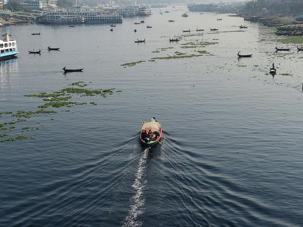 Bangladeshi commuters use boats to cross the Buriganga River in the capital Dhaka in 2018. In July, Bangladesh's top court granted all the country's rivers the same legal rights as humans.