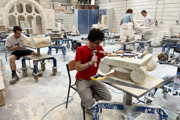 Students chip and chisel away at heavy slabs of stone in the workshops of the Hector Guimard high school, less than three miles from Paris' Notre Dame cathedral.
