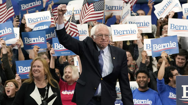 Sen. Bernie Sanders takes the stage during a primary night event on Tuesday in Manchester, N.H. His victory, projected by The Associated Press, comes in another close race with Pete Buttigieg.