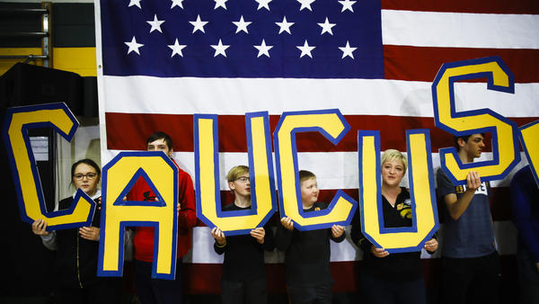 Attendees hold letters that read "CAUCUS" during a campaign event for Democratic presidential candidate and former South Bend, Ind., Mayor Pete Buttigieg in Iowa earlier this month.