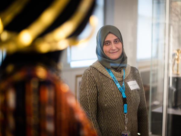 The University of Pennsylvania Museum of Archaeology and Anthropology — known as The Penn Museum — has hired refugees and immigrants from the Middle East, Africa and Central America as part of their "Global Guides" program. Moumena Saradar, who is originally from Syria, stands next to the wedding jewelry and headdress of Queen Puabi, her favorite part of the Middle East gallery.