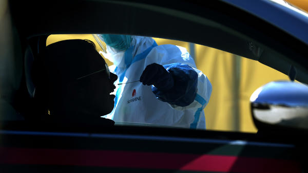 A motorist gets a drive-through coronavirus test Thursday in Daly City, Calif. The U.S. has surpassed China to have the world's largest number of coronavirus cases.