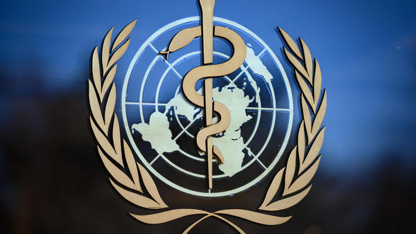 The logo of the World Health Organization (WHO) at its headquarters in Geneva. The organization says the coronavirus is primarily transmitted "through respiratory droplets and contact routes," not airborne transmission.