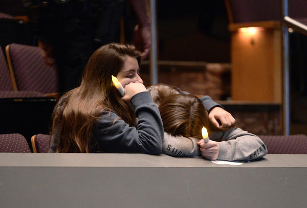 Mourners comfort each other Thursday during a vigil at the Thousand Oaks Civic Arts Plaza for the victims of the mass shooting at Borderline Bar and Grill in Thousand Oaks, Calif.