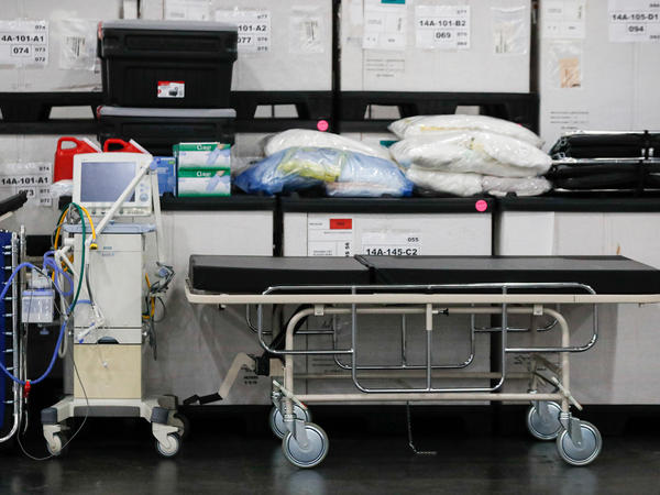 A ventilator alongside medical supplies and a stretcher is displayed before a news conference at the Javits Center in New York City on March 23.