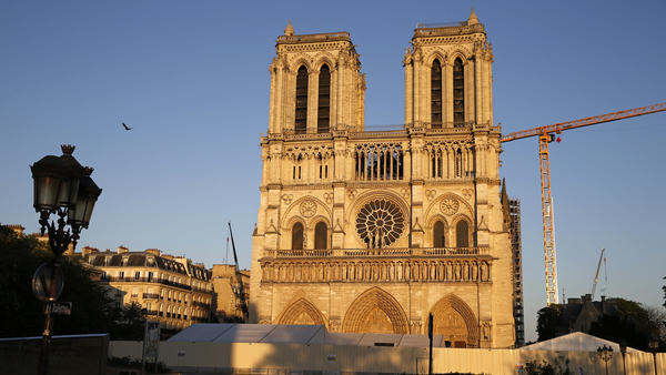 Notre Dame cathedral is seen at sunset Tuesday, after repair work stops due to the coronavirus outbreak. Wednesday marks the first anniversary of the devastating fire that destroyed many parts of the Gothic cathedral.