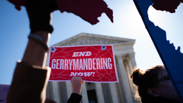 An activist holds a sign outside the U.S. Supreme Court in 2019.