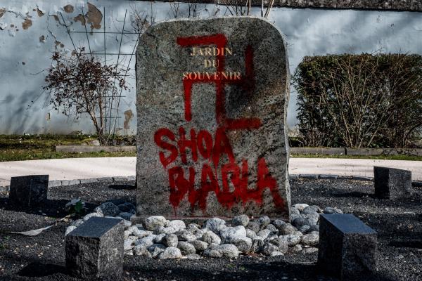 In this Feb. 20 photograph, a Nazi sign and words mocking the Holocaust were painted on a tombstone at the Garden of Remembrance in the cemetery in Champagne-au-Mont-d'Or, near Lyon, France.