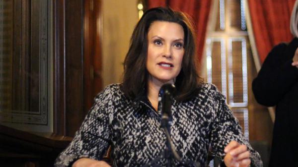 Michigan Gov. Gretchen Whitmer addresses the state during a speech in Lansing, Mich., on Monday. Whitmer says she's listening to "the best medical advice" on when to ease restrictions.