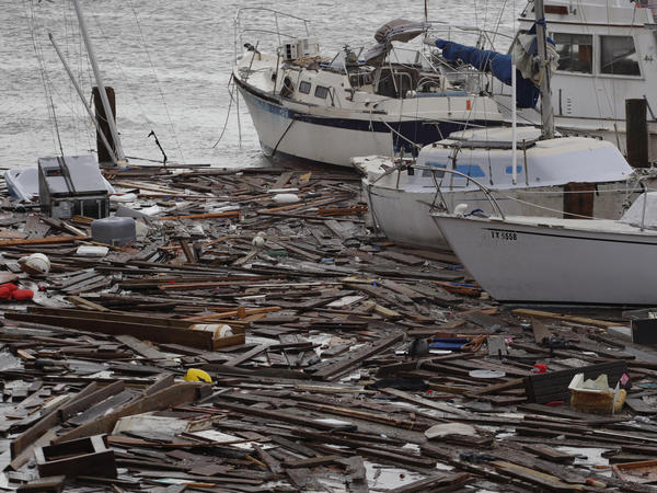Broken boats and floating debris at a marina in Corpus Christi are among the damage caused by Hurricane Hanna, which was downgraded to a tropical storm and continued to shower Texas with heavy rain on Sunday.
