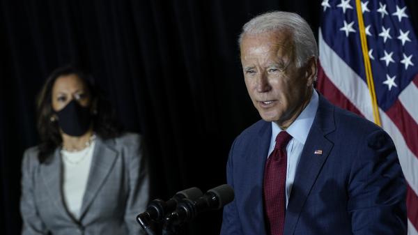 Presumptive Democratic presidential nominee Joe Biden speaks Thursday after a coronavirus briefing with health experts and his newly named running mate, Sen. Kamala Harris, at the Hotel DuPont in Wilmington, Del. Biden took off his mask to speak.