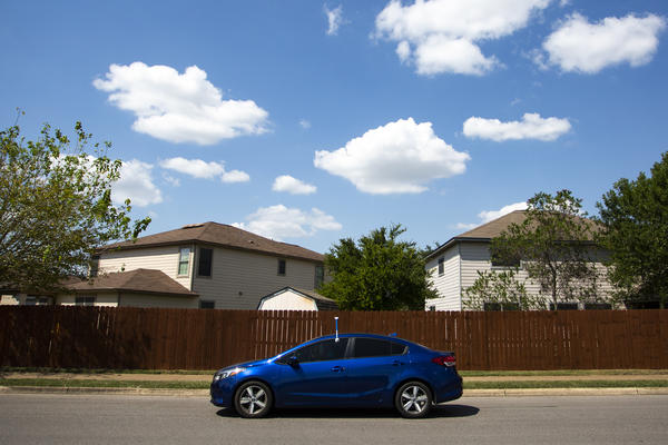 Frances Acuña drives through southeast Austin with a sensor attached to her driver's side door. It's part of a federal study to measure rising urban heat.