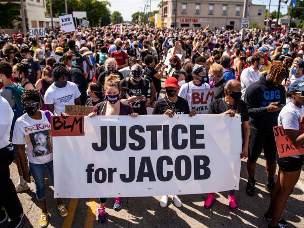 Protesters march with the family of Jacob Blake during a rally against racism and police brutality in Kenosha, Wisconsin, on August 29, 2020.