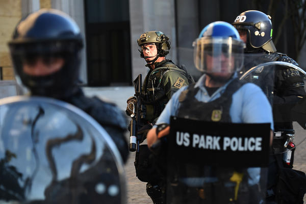 U.S. Park Police and other federal officers hold a perimeter near the White House on June 1 as demonstrators gather to protest the killing of George Floyd.