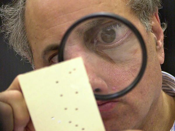 Judge Robert Rosenberg, a member of the Broward County, Fla., canvassing board examines a disputed ballot in Fort Lauderdale, Fla., on Nov. 24, 2000. That close presidential contest was one of several in U.S. history.
