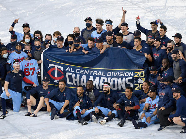 The Minnesota Twins celebrate being the American League Central Division champions after the game against the Cincinnati Reds on Sunday in Minneapolis.