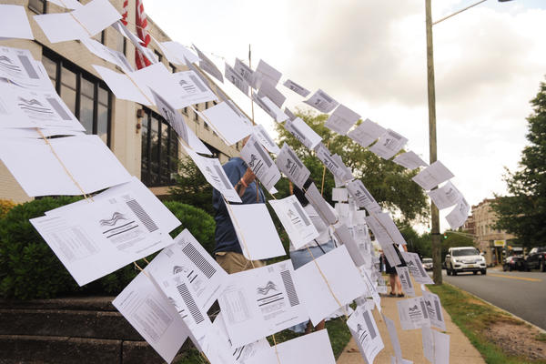 A rally outside the Montclair, N.J., town hall on July 1. Protesters hung 1,101 absentee ballots to represent the number of votes that weren't counted in a mayoral election that was decided by just 195 votes.
