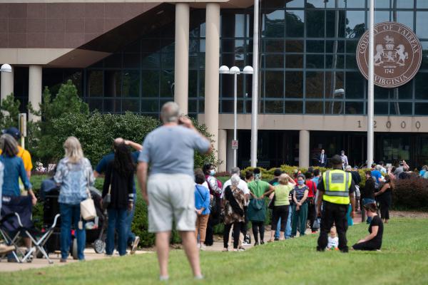 Voters wait in line to cast their ballot at an early voting location in Fairfax, Va., on Sept. 18. Growing tensions in the country have some election officials worried about potential violence at polling places.
