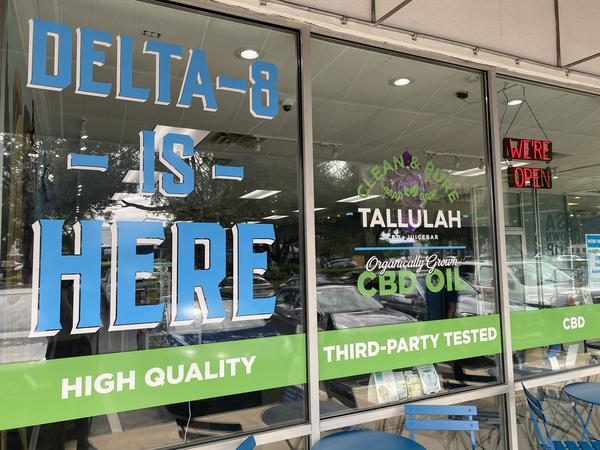 Outside of Tallulah CBD Juice Bar, where a display reads that Delta-8, a type of THC, is sold here.