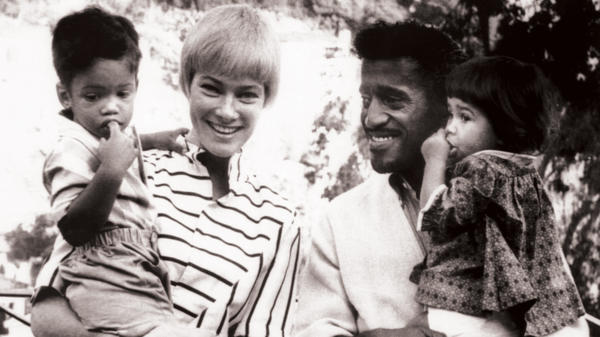 Sammy Davis, Jr. holds daughter Tracey in a family picture taken in 1962.