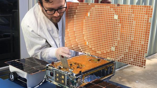Engineer Joel Steinkraus tests solar panels on one of two CubeSats that made up NASA's Mars Cube One mission. The MarCO CubeSats — the first to be sent into deep space — flew to Mars and relayed telemetry from NASA's InSight lander.