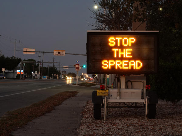 A sign warning motorists about the coronavirus in Key West, Fla. The U.S. Senate passed a $2 trillion relief measure Wednesday night intended to help hospitals, workers and businesses hit hard by the rapidly spreading virus.