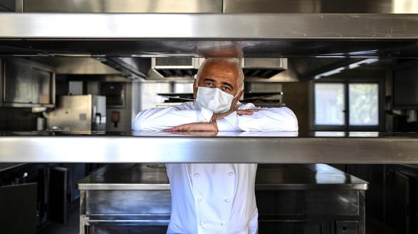 French chef Guy Savoy poses with a face mask in the kitchen of one of his restaurants, in the Monnaie de Paris building, on Tuesday.