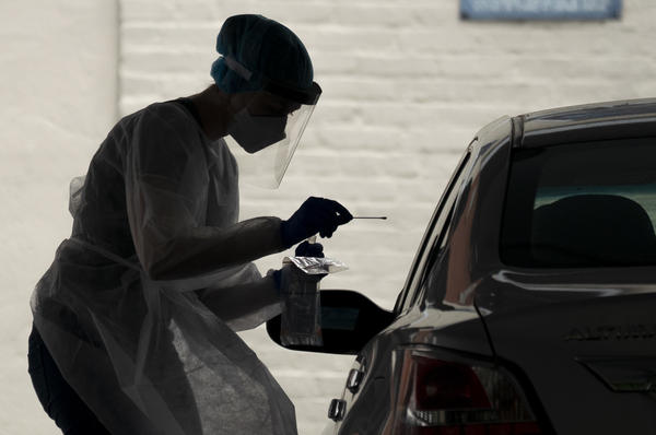 A medical professional administers a coronavirus test at a drive-thru testing site run by George Washington University Hospital, on May 26, 2020 in Washington, D.C.