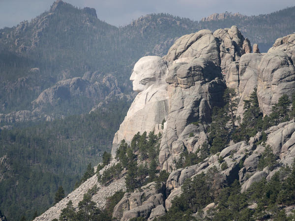 The bust of President George Washington looks out over the Black Hills at Mount Rushmore National Monument. President Trump is expected to visit the monument and make remarks before the start of a fireworks display on Friday.