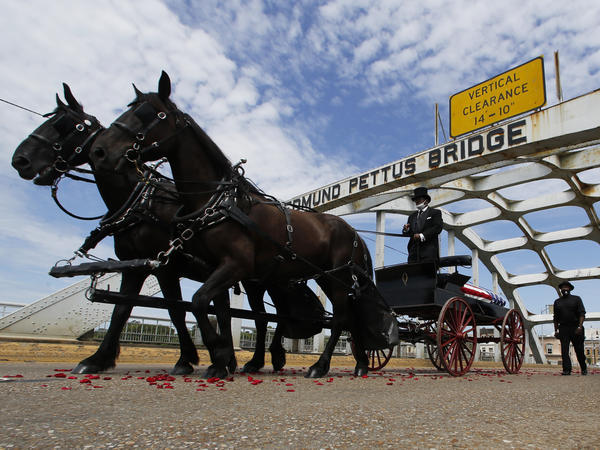 The casket of Rep. John Lewis crosses the Edmund Pettus Bridge by horse-drawn carriage during a memorial service for Lewis on July 26 in Selma, Ala.
