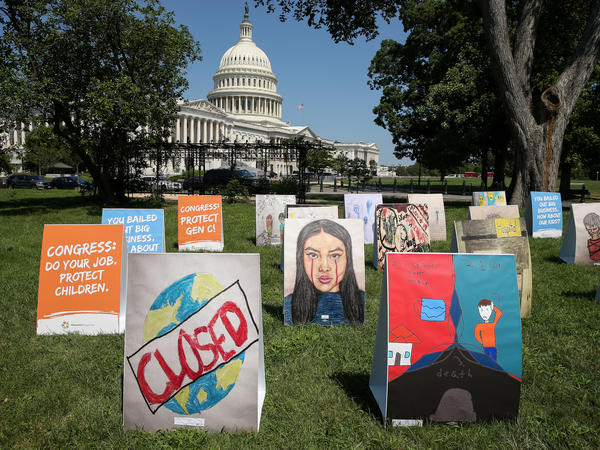 An installation of children's art is set up outside the Capitol on Wednesday. Kids can develop "severe" symptoms from the coronavirus, the Centers for Disease Control and Prevention said in a report released Friday.