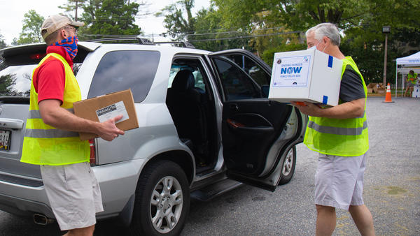 Volunteers from St. John's Episcopal Church in Bethesda help hand out food to a local resident at an event earlier this month.