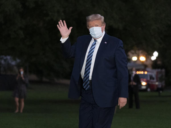 President Trump waves as he returns to the White House on Monday after leaving Walter Reed National Military Medical Center.
