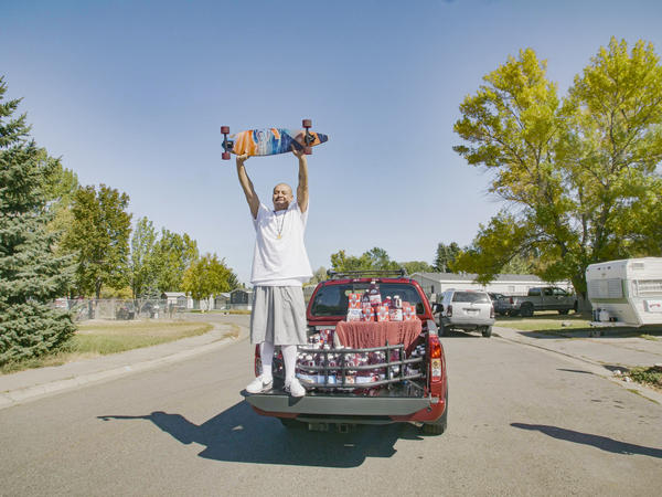 Nathan Apodaca's TikTok video, in which he longboards to Fleetwood Mac's "Dreams," has catapulted him to viral fame. Here, he is standing in the pickup truck given to him by Ocean Spray. In his video, Apodaca sips from a bottle of Ocean Spray's Cran-Raspberry juice.