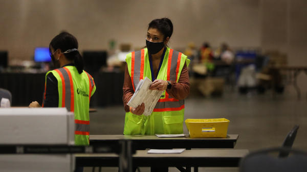 Election workers in Philadelphia count ballots on Tuesday. Pennsylvania is among several swing states that have yet to be called.