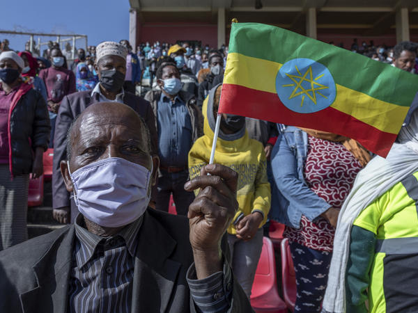 A man holds a national flag as he waits to donate blood in support of Ethiopia's military in Addis Ababa on Thursday. Rallies occurred in multiple cities in support of the government's military offensive against the Tigray People's Liberation Front.