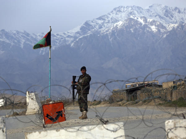 An Afghan National Army soldier stands guard at a checkpoint near the Bagram airfield, the largest U.S. military base in Afghanistan, in April.