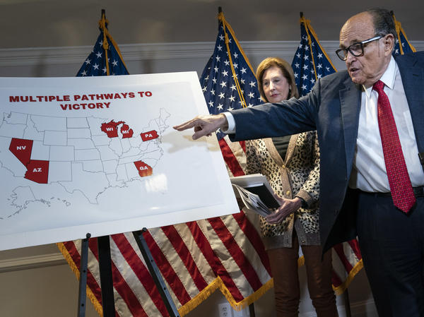 President Trump's lawyer Rudy Giuliani points to a map Thursday while speaking to the press about lawsuits related to the 2020 election at the Republican National Committee headquarters in Washington, D.C.