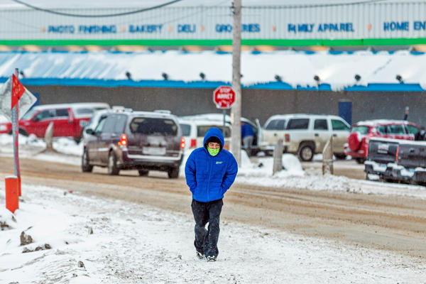 A man wears a mask as the territory of Nunavut enters a two week mandatory restriction period in Iqaluit, Nunavut, Canada, on Wednesday. More than 80 COVID-19 cases have been identified this month in Nunavut, where around 39,000 people, predominantly Inuit, live in communities scattered across the territory.