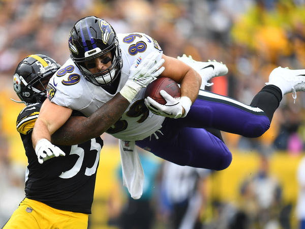 Mark Andrews, right, of the Baltimore Ravens hurdles Devin Bush, left, of the Pittsburgh Steelers during the first quarter at Heinz Field on Oct. 6, 2019 in Pittsburgh. This season, the Thanksgiving matchup between the two teams has been canceled due to a coronavirus outbreak.