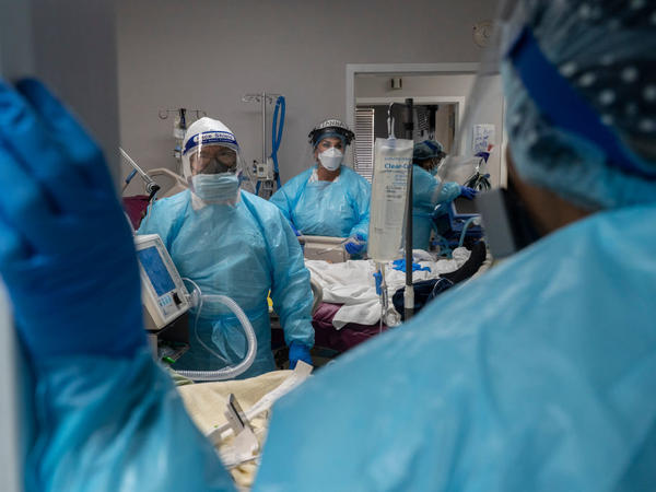 Medical staff prepare for an intubation procedure on a COVID-19 patient in a Houston intensive care unit. In some parts of the U.S., as hospitals get crowded, hospital leaders are worried they may need to implement crisis standards of care.