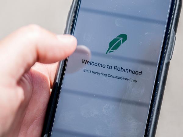 The Robinhood investment app appears on a smartphone in this photo illustration. Day trading has surged during the coronavirus pandemic as stay-at-home people try buying and selling stocks, often for the first time.