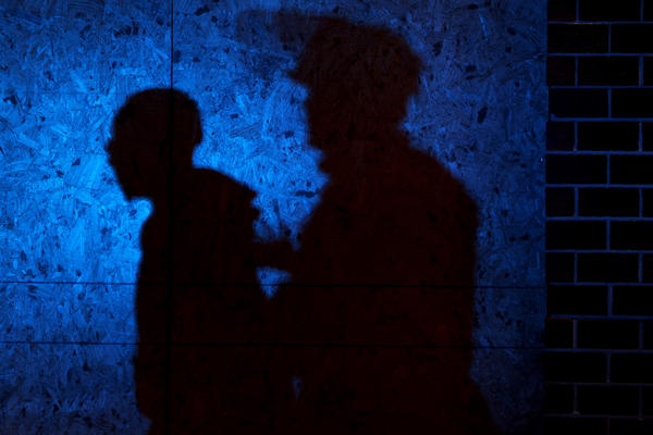 The shadow of a Louisville Police officers arresting a demonstrator is seen on a wall on September 23, 2020 in Louisville, Kentucky. (Michael M. Santiago/Getty Images)
