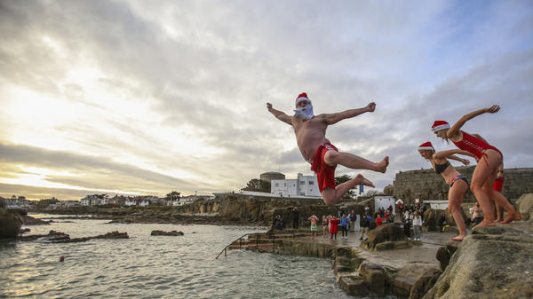 People take part in the annual Christmas Day swim at the Forty Foot bathing spot in Sandycove Dublin, Ireland, Dec. 25, 2020.